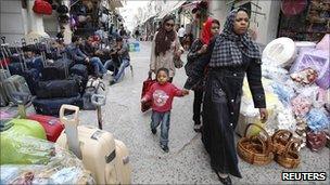 Women walk through a market in the old town of Tripoli on Tuesday