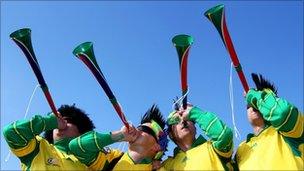 South African fans blow Vuvuzelas