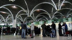 Passengers waiting to check-in at Baghdad airport departure hall