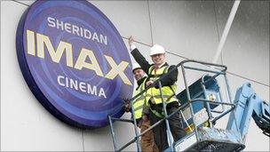 Workers remove Imax cinema sign