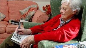 Elderly woman doing the crossword