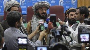 Pakistani tribal elder Malik Jalal, center, flanked by newsmen addresses a news conference to condemn the recent U. S. drone attack in North Waziristan which killed many people, Friday, March 18, 2011 in Peshawar, Pakistan.