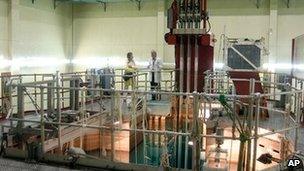 Scientists stand by the nuclear reactor RECH-1, located in the pool of water below, at the Nuclear Study Center in Santiago, Chile, on 18 February.