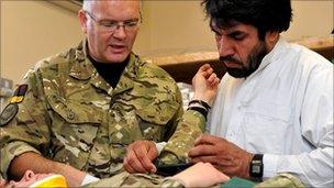 Captain Robert Garbett training an Afghan nurse