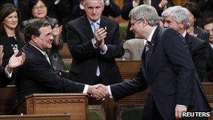 Finance Minister Jim Flaherty (left) shakes hands with Canadian Prime Minister Stephen Harper (right)