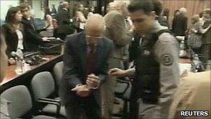 Video grab showing Jorge Videla being shown to his seat on the first day of the trial - 28 February 2011