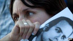 A relative of a victim reacts as she hears the sentences given to 30 leaders of the military government outside the courtroom in Cordoba, Argentina on December 22, 2010