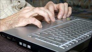 Man typing on laptop computer