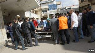 An injured man arrives at a hospital in Deraa (23 March 2011)