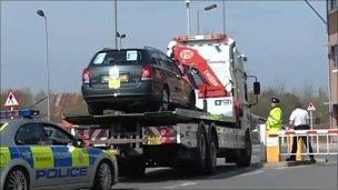 The Toyota car being taken away