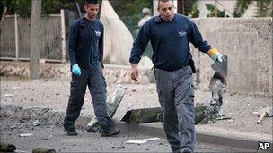 Israeli police with wreckage of missile in Beersheba, southern Israel. 23 March 2011
