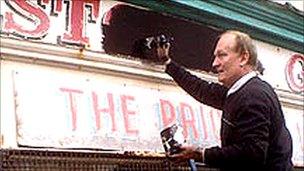 Vale of Clwyd MP Chris Ruane paints out the sign in Rhyl