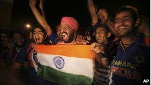 Indian fans celebrate the victory of their team over Australia in the ICC Cricket World Cup quarter-final match, in Kolkata, India, Thursday, March 24, 2011