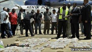 Kenyan police chief, Mathew Iteere (2R) is shown bags of heroin displayed on March 25, 2011 at the Wilson airport in Nairobi. Kenyan