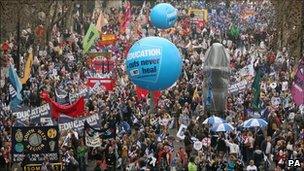 Demonstrators assemble near Waterloo Bridge before the start of the anti-cuts march, 26 March 2011