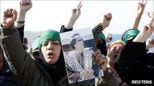 Libyan women hold pictures of Col Gaddafi. Photo: 24 March 2011