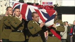 Coffin drapped in the Union flag carried by soldiers