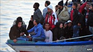 A migrant boat from Tunisia arriving at Lampedusa, 27 Mar 11