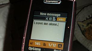 Girl writes "Leave me alone" in a text message (generic)