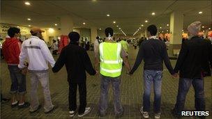 Anti-government protesters form a human chain at the Salmaniya Hospital fearing an attack by riot police in Manama, 15 March