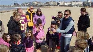 Project officer Suzie Hooper with people on the beach