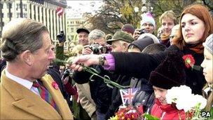 Woman hits Prince Charles with flower