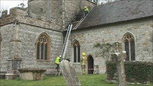 Firefighters and the fire-damaged church