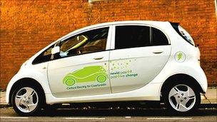 A white i-MiEV with council branding, parked in a street.