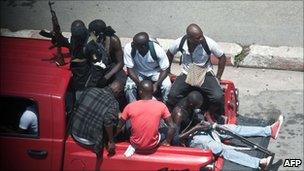 Pro-Gbagbo militiamen patrol in the empty streets of Abidjan