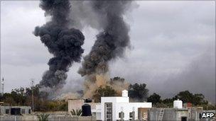 Smoke rises over Tripoli from coalition air strikes