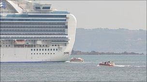 Tenders travel to and from a cruise ship moored off Guernsey