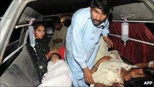 Pakistani blast victims wait for help in an ambulance outside a hospital in Multan on April 3, 2011