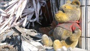 A discarded Winnie the Pooh sits amid debris left in the city of Otsuchi in north-eastern Japan