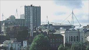 Picture of Cardiff skyline showing the Millennium Stadium peeking out behind tall buildings