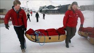 Prince Harry and Martin Hewitt load their kit before the flight to the Borneo Ice field