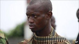 Fighter loyal to Alassane Ouattara guards a checkpoint at one of the main entrances to Abidjan, 5 April