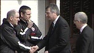 Tom Elliot and Danny Kennedy shake hands with Tyrone GAA manager Mickey Harte at Ronan Kerr's funeral