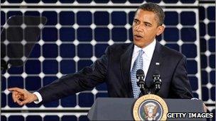 President Barack Obama in front of a solar panel