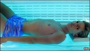 Teenage boy on a sunbed