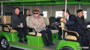 North Korean leader Kim Jong-il (C) visits the Amnokgang Tyre Factory; undated picture released by KCNA 7 April 2011