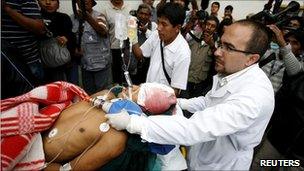 A man on a stretcher is taken to hospital after being injured during protests in Arequipa on 7 April 2011