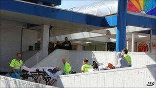 Injured people are carried out of a shopping mall after a shooting in Alphen aan den Rijn, 15 miles (25km) southwest of Amsterdam, Netherlands, 9 April 2011