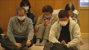 Homeless survivors pray at Kamaishi's temple