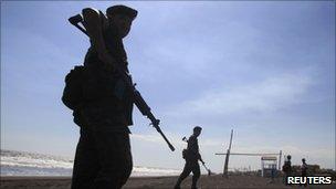 Soldier patrols beach in Guatemala