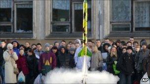 Children watch a model rocket blasting off during a celebration of the 50th anniversary of the Yuri Gagarin's first manned flight into space at a school in St Petersburg, Russia