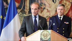 French Defence Minister Gerard Longuet (L) speaks near CEMA admiral Edouard Guillaud during a press conference on April 11, 2011 in Paris
