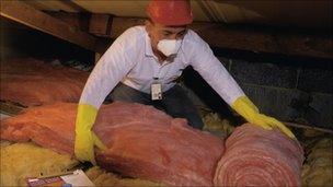 Man fitting loft insulation