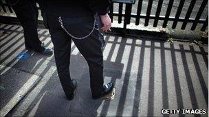 A prison officer stands outside Birmingham Prison, March 2011