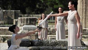 Actresses pass the flame at the lighting ceremony in Olympia ahead of the Vancouver 2010 Winter Olympics