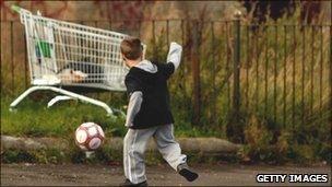 Child playing football (generic)